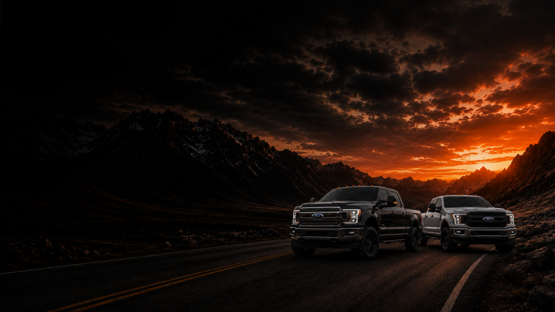 2 Ford Powerstroke 6.7L trucks on a paved road with a sunset in the background