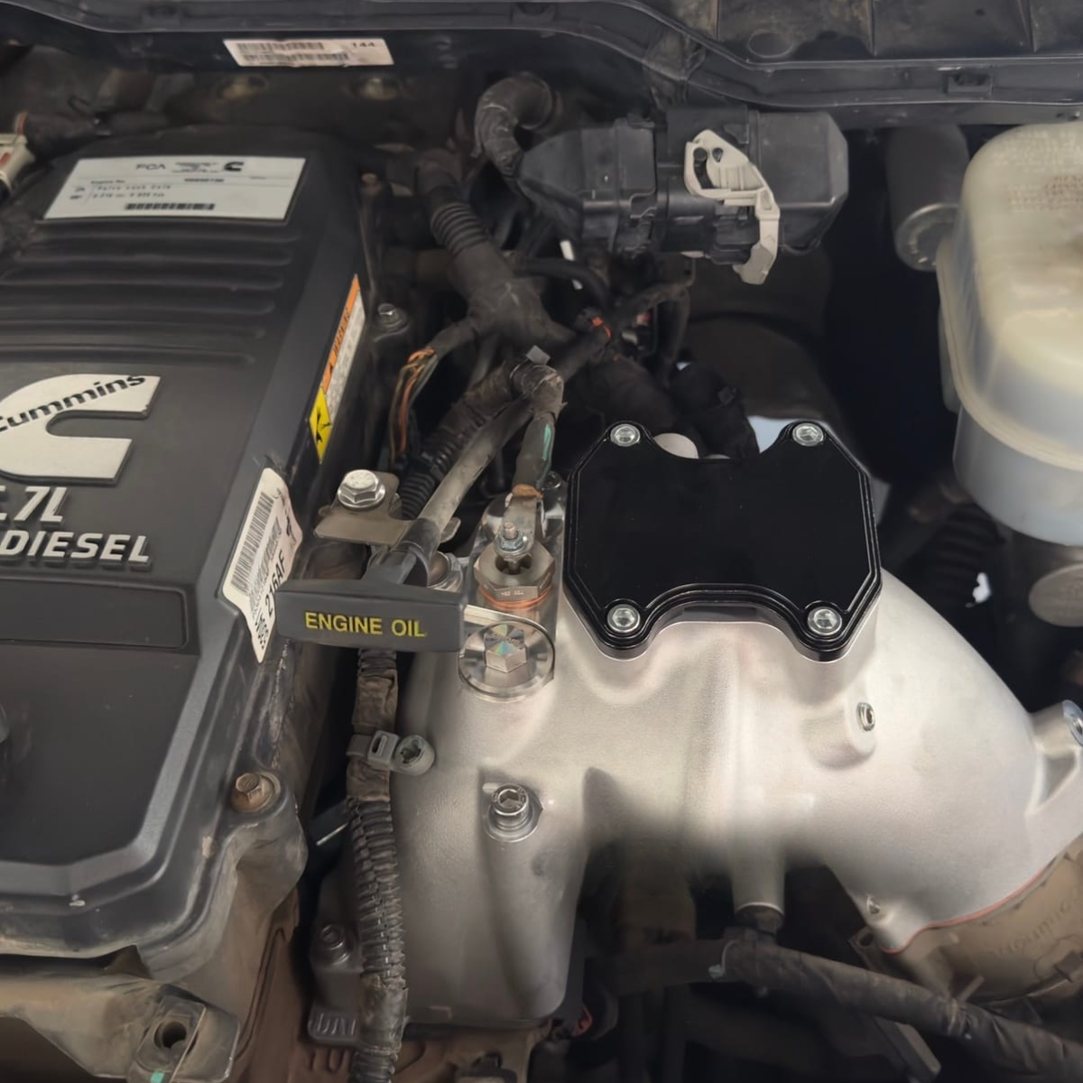 Customer-uploaded photo of a 6.7L Cummins EGR delete kit installed on a Ram diesel engine.
