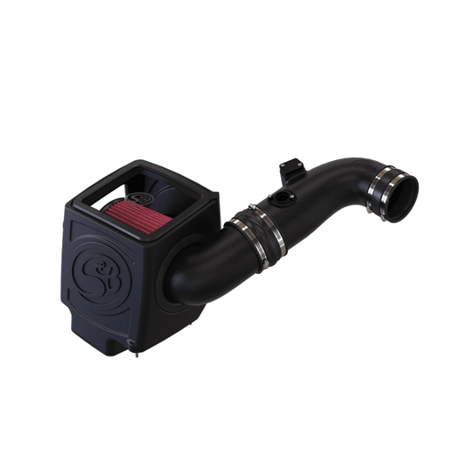 S&B cold air intake kit for a 6.6L Duramax engine, featuring a black enclosed airbox with a clear inspection lid, a large cone air filter, and a smooth black intake tube with silicone couplers.